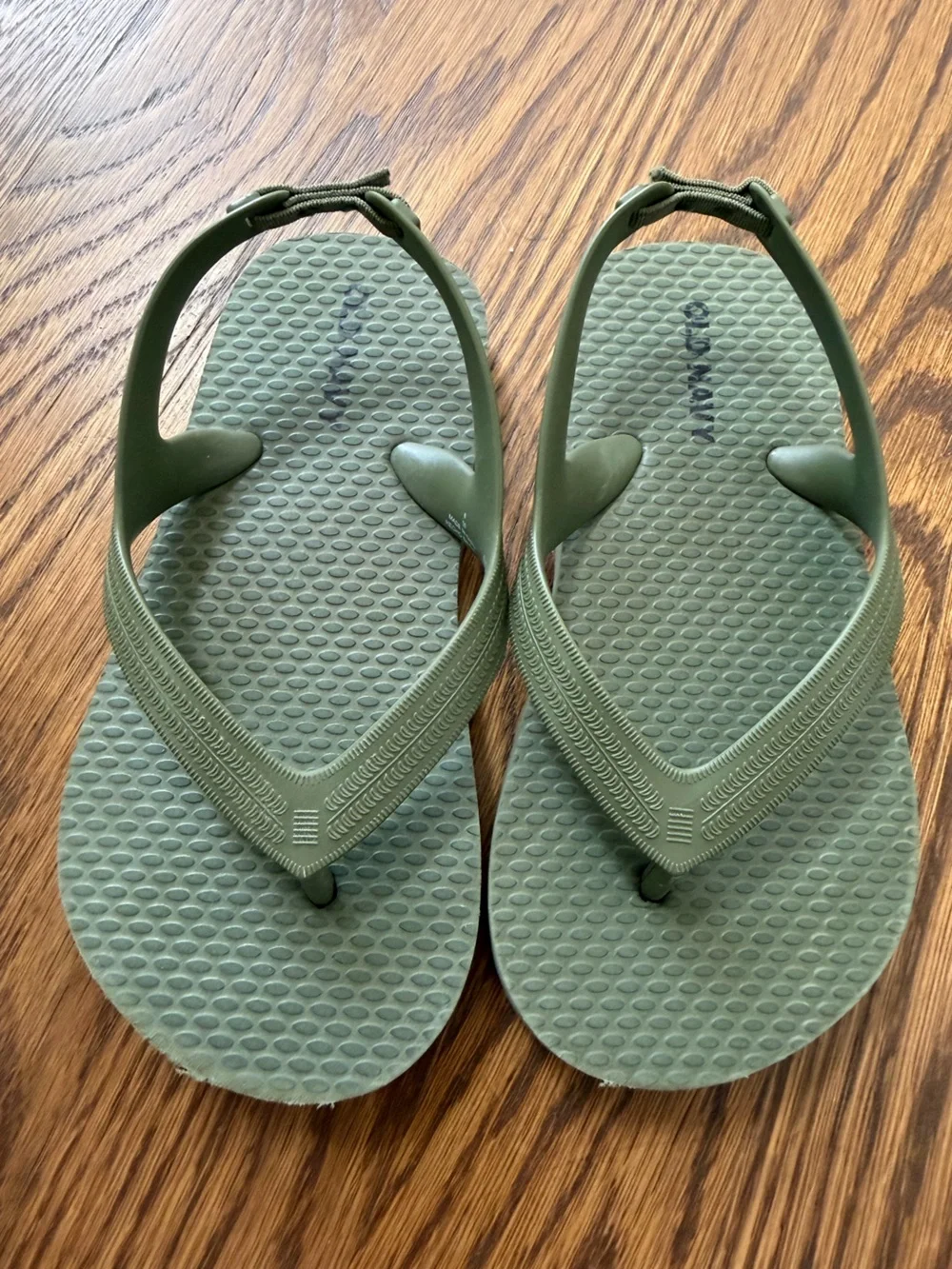 Old Navy olive green flip flops, toddler size 8